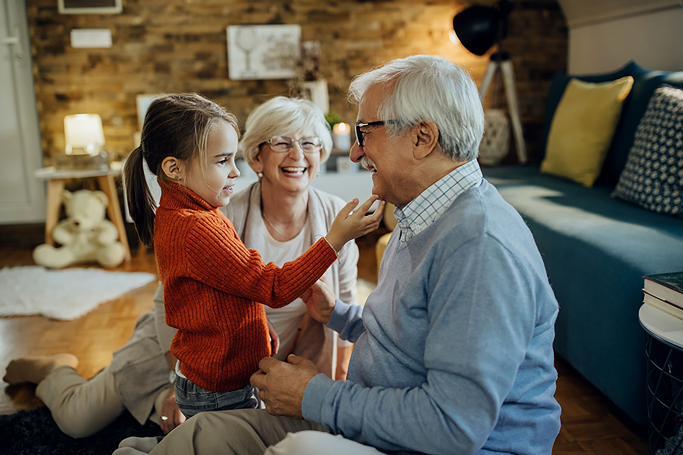 Image of Cute small girl spending time with her grandparents at home.